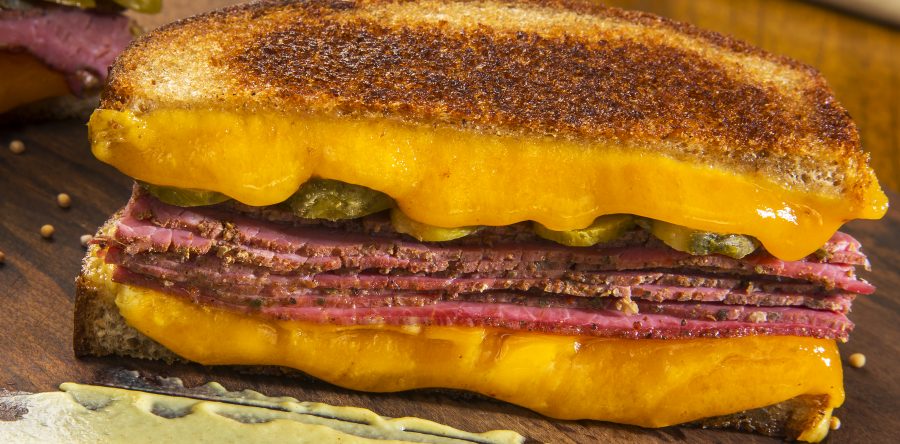 Sanduíche de pastrami no pão australiano com cheddar inglês, mostarda dijon e picles